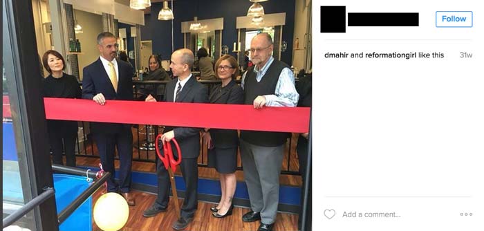 guy cutting grand opening ribbon