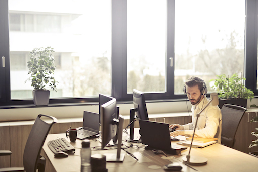 Man with headphones working at desk
