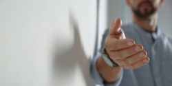 Man reaching out his hand towards the camera