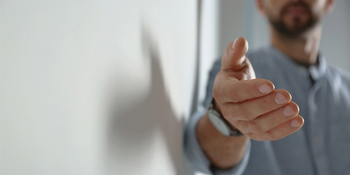 Man reaching out his hand towards the camera